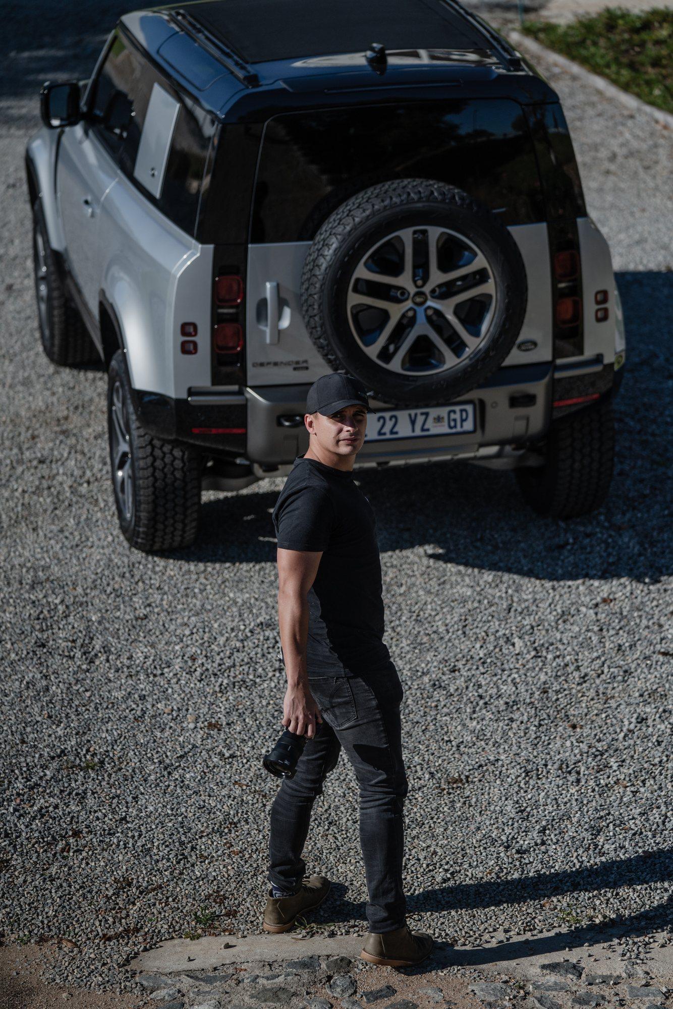 Louw Lemmer at work, camera in hand by his Defender